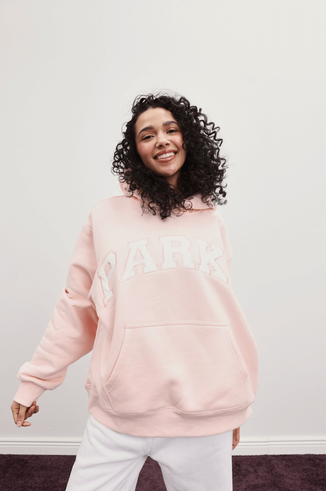 girl wearing varsity hoodie -ballet + white