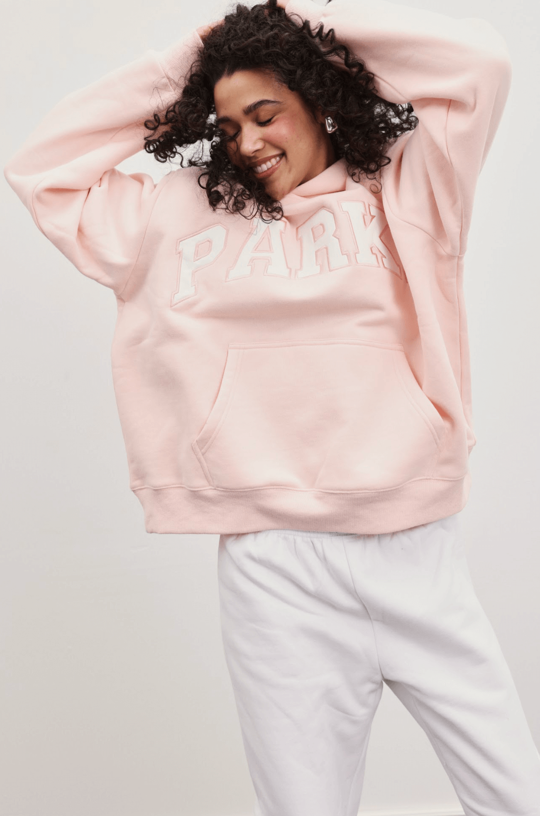 girl wearing varsity hoodie -ballet + white
