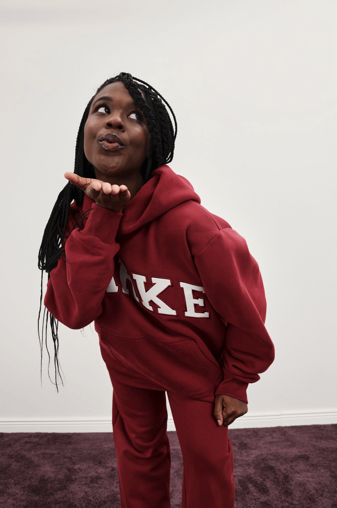 girl wearing varsity hoodie -burgundy + white
