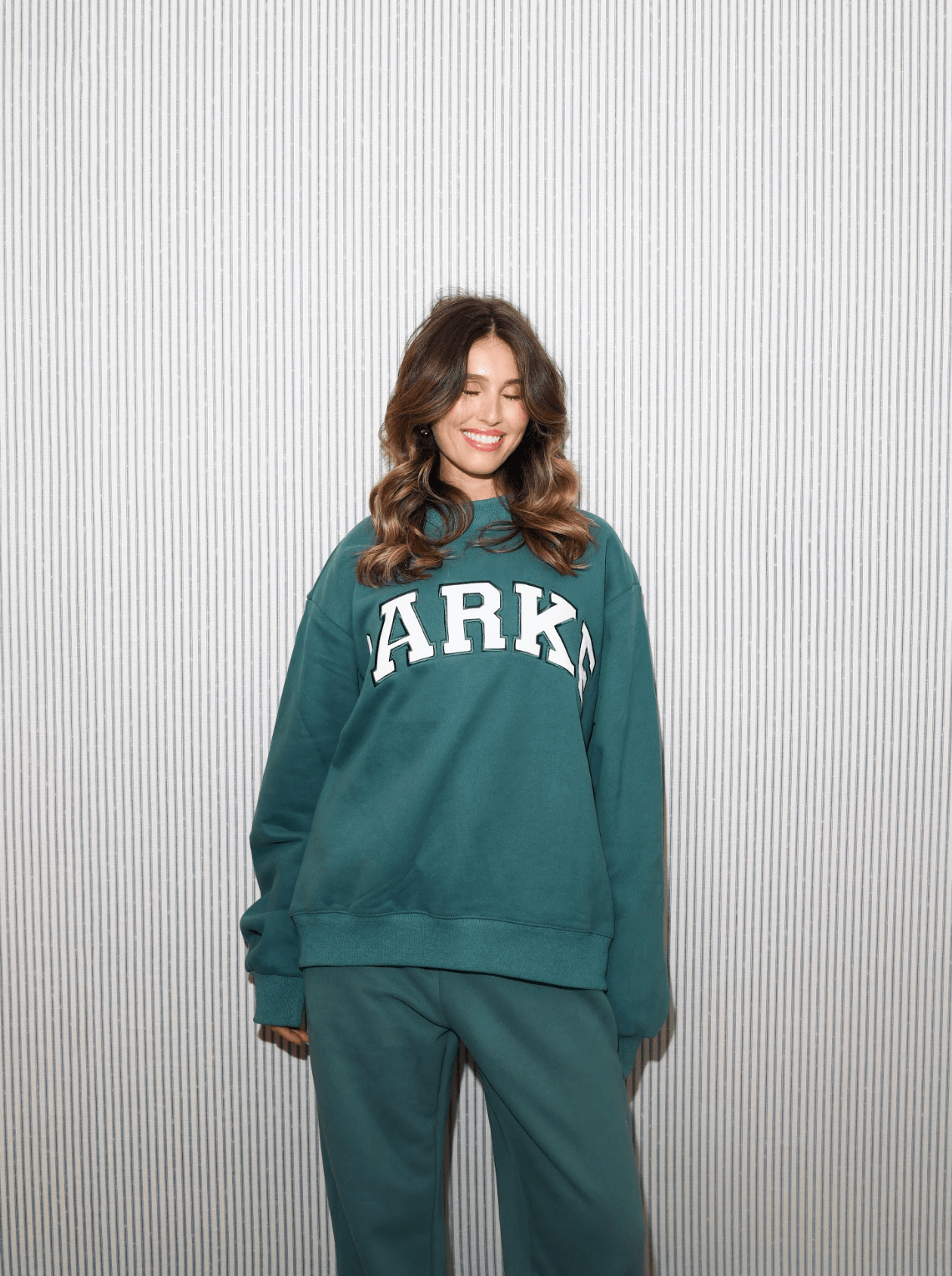 girl wearing varsity mockneck -evergreen + white
