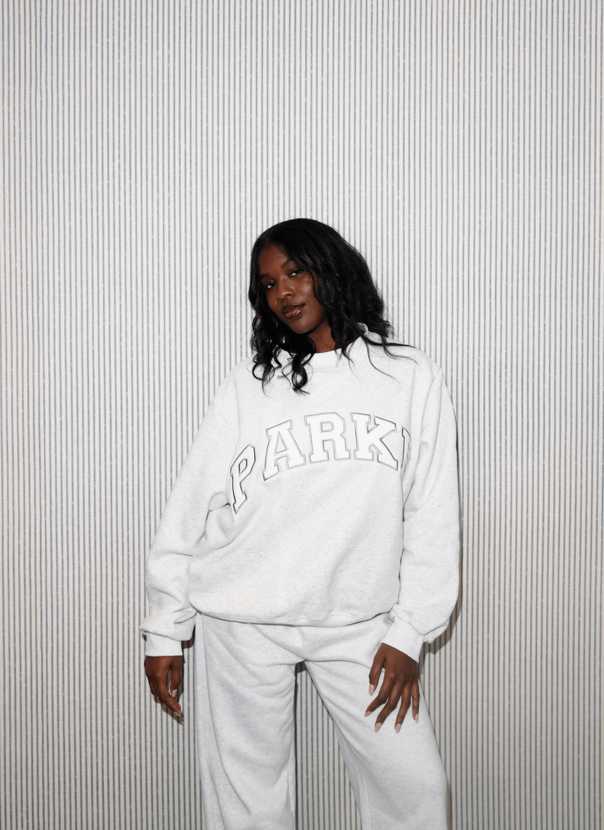 girl wearing varsity mockneck -heather grey + white