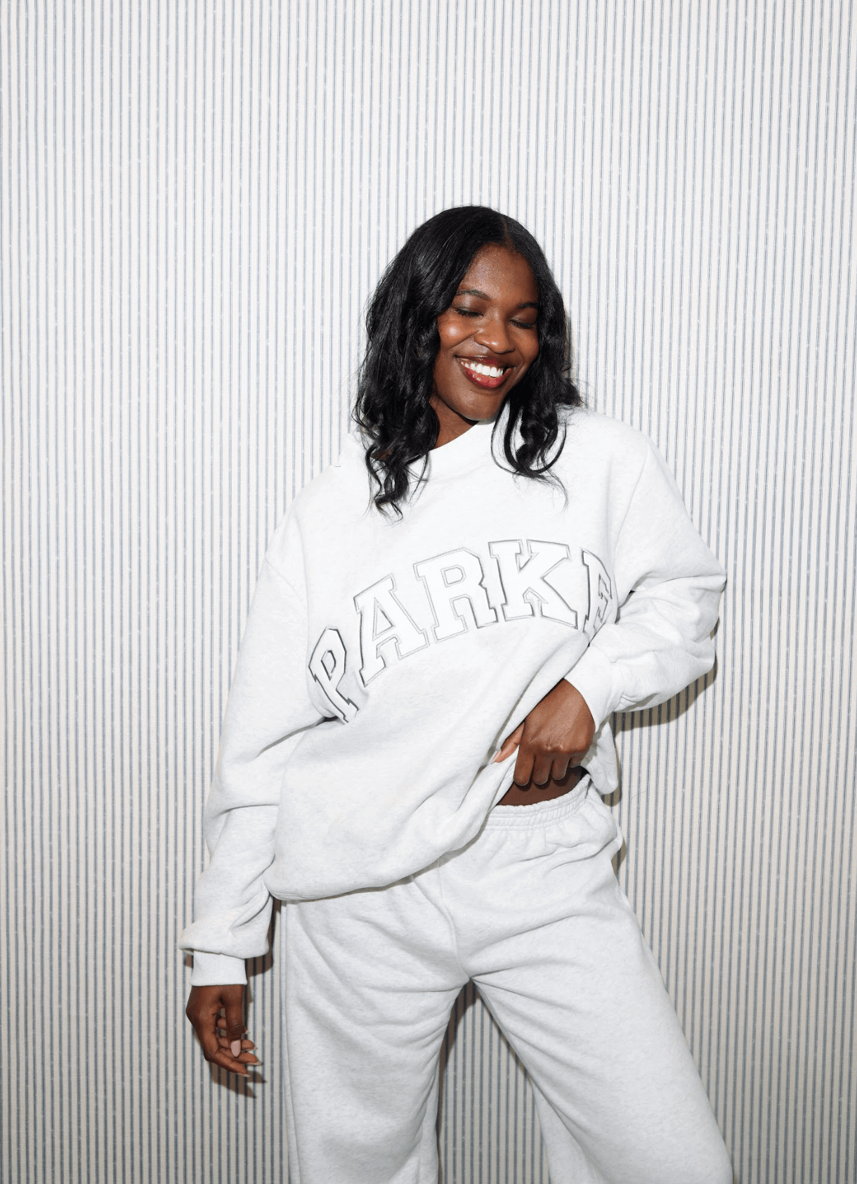 girl wearing varsity mockneck -heather grey + white