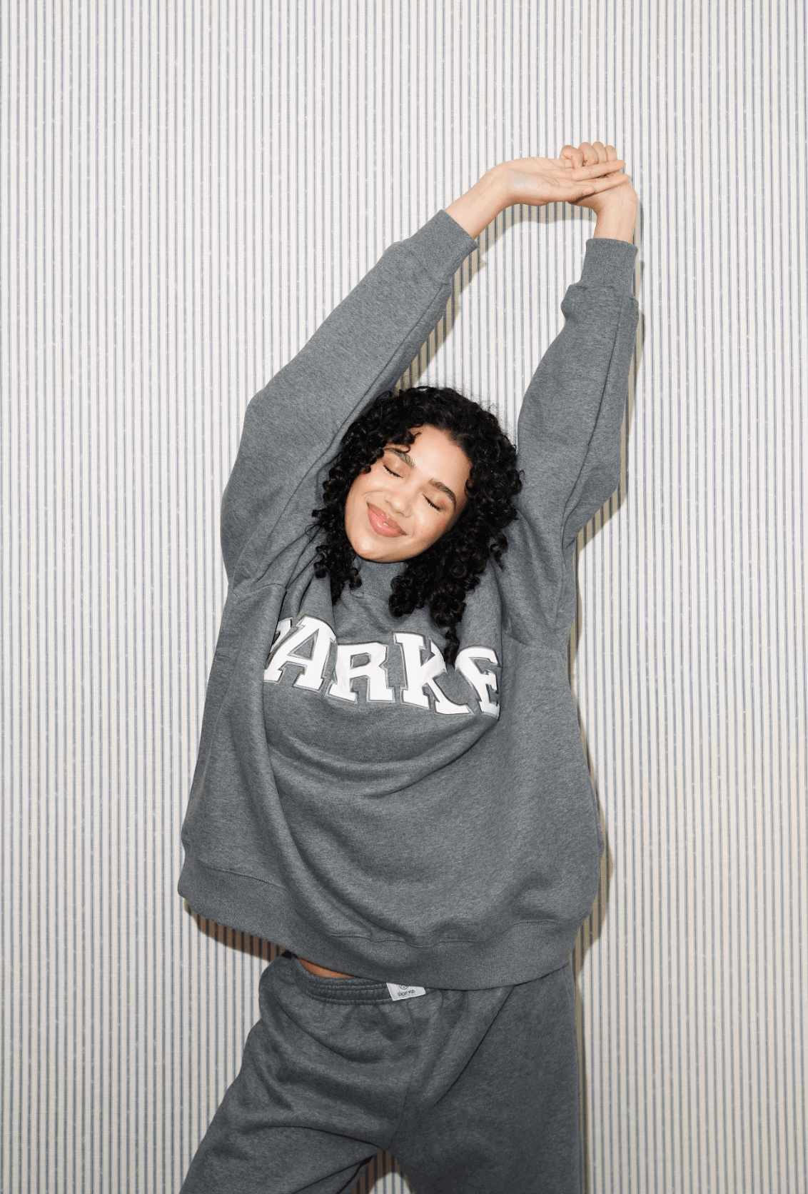 girl wearing varsity mockneck -stormy + white