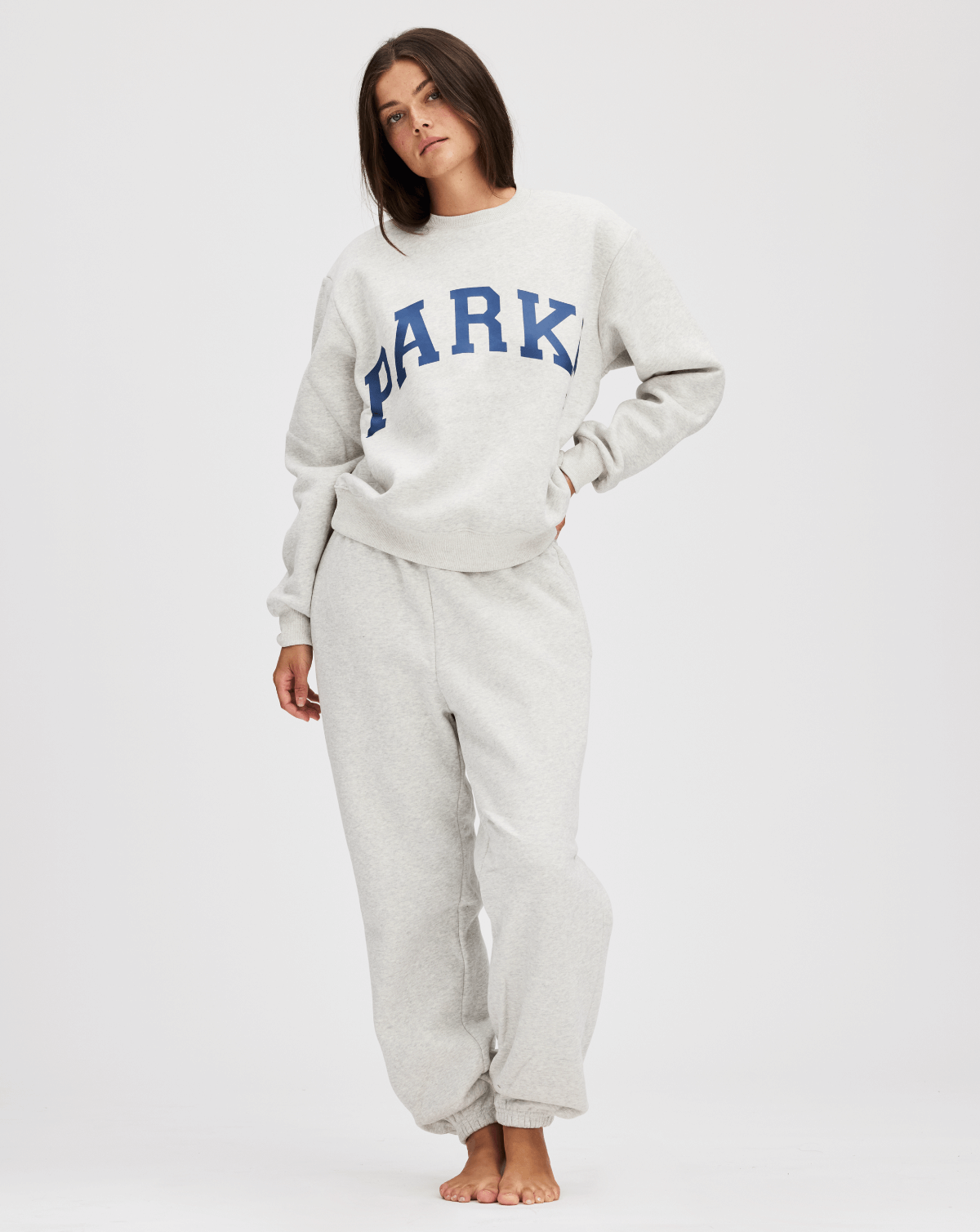 model wearing varsity crewneck sweatshirt -classic grey + navy