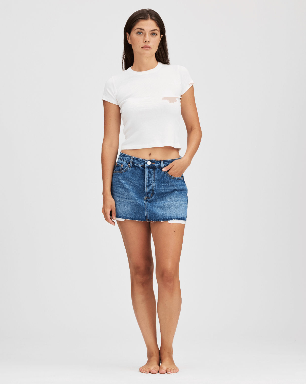 girl wearing denim mini skirt -med wash