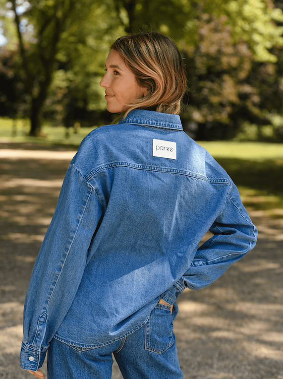 girl showing back of med wash long sleeve denim shirt - med wash