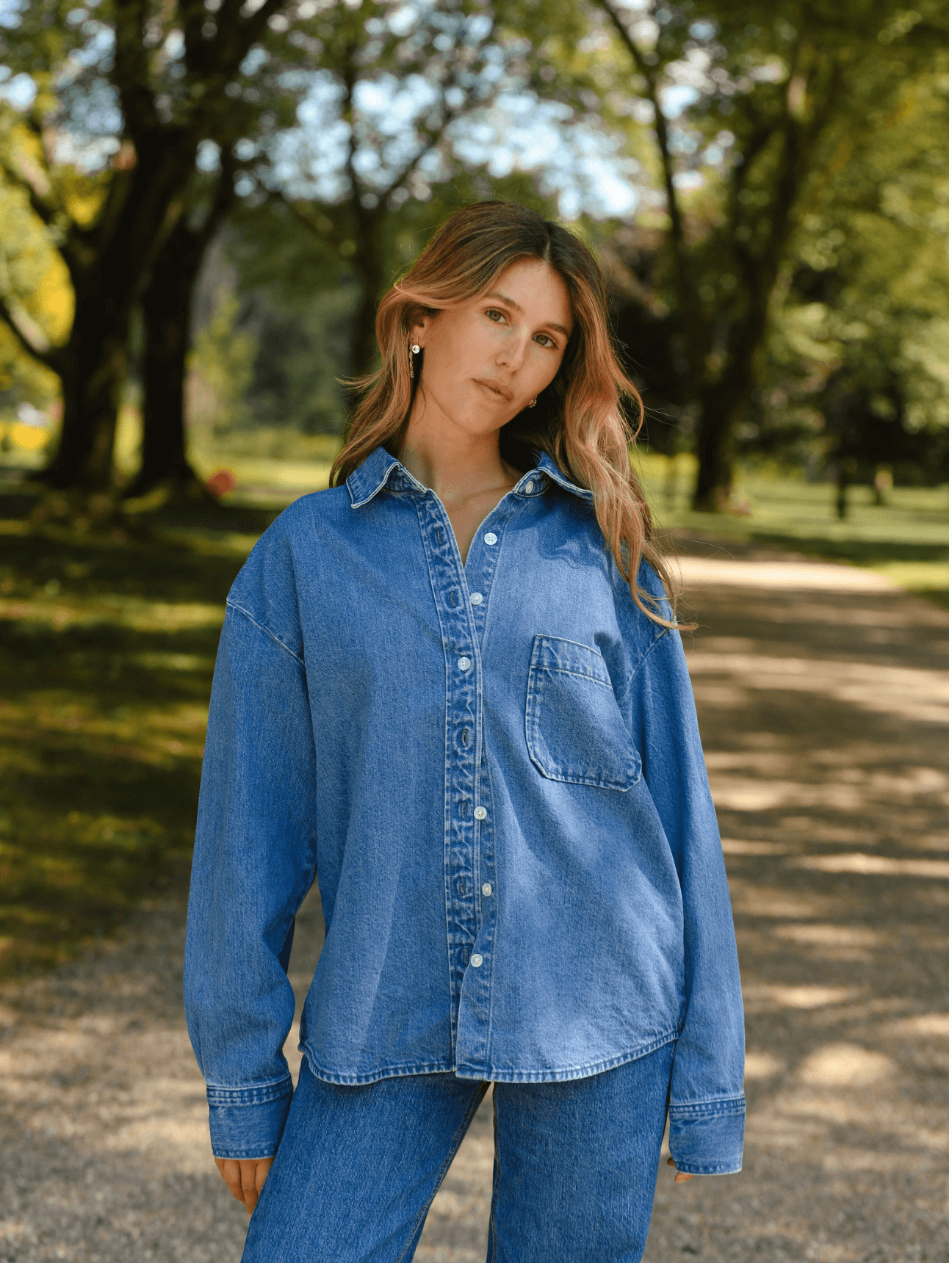 girl showing front of long sleeve button down - med wash