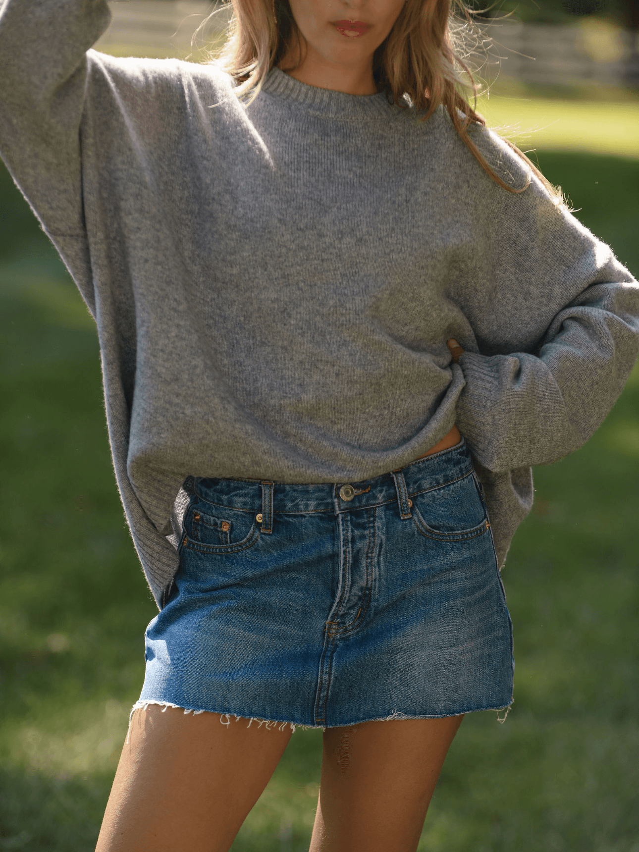 girl wearing denim mini skirt -medium wash