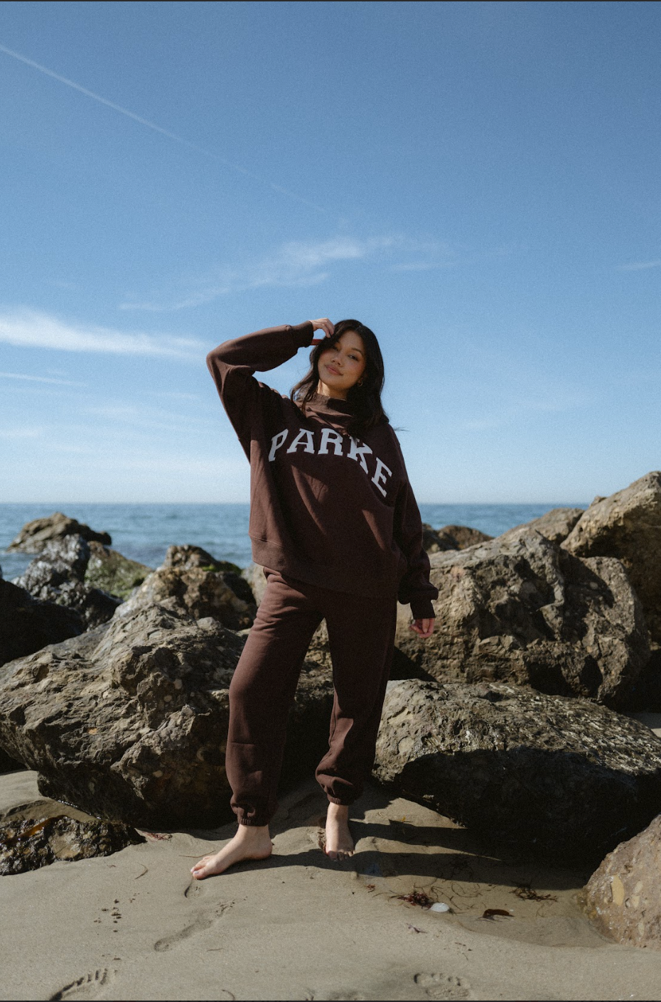 model wearing unisex sweats -chocolate brown + white