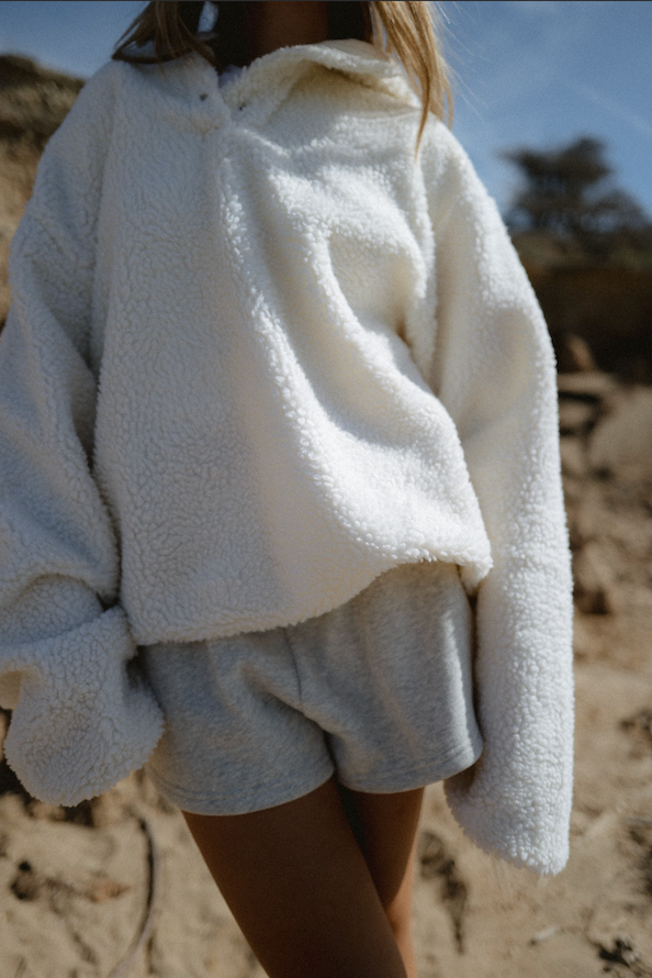close up of girl wearing cream hooded fleece - cream