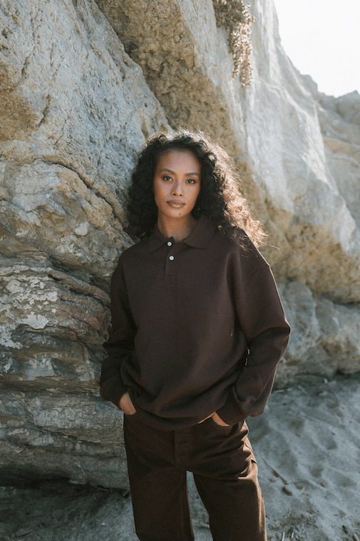 girl showing front of long sleeve polo - chocolate
