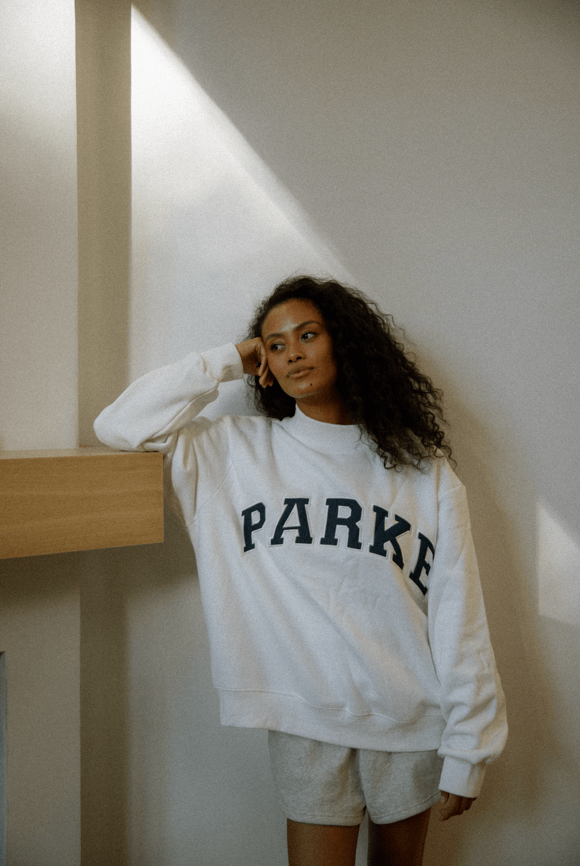 girl wearing white + navy varsity mockneck -white + navy