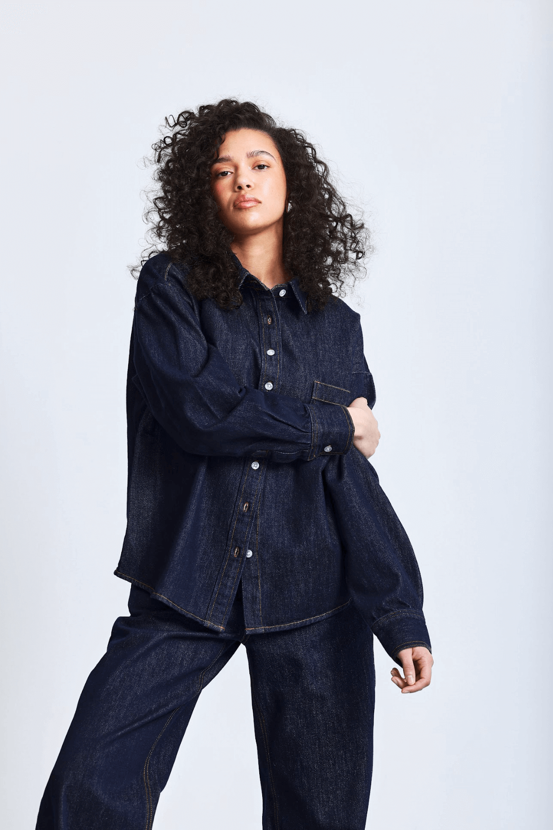 girl wearing long sleeve button down - dark wash