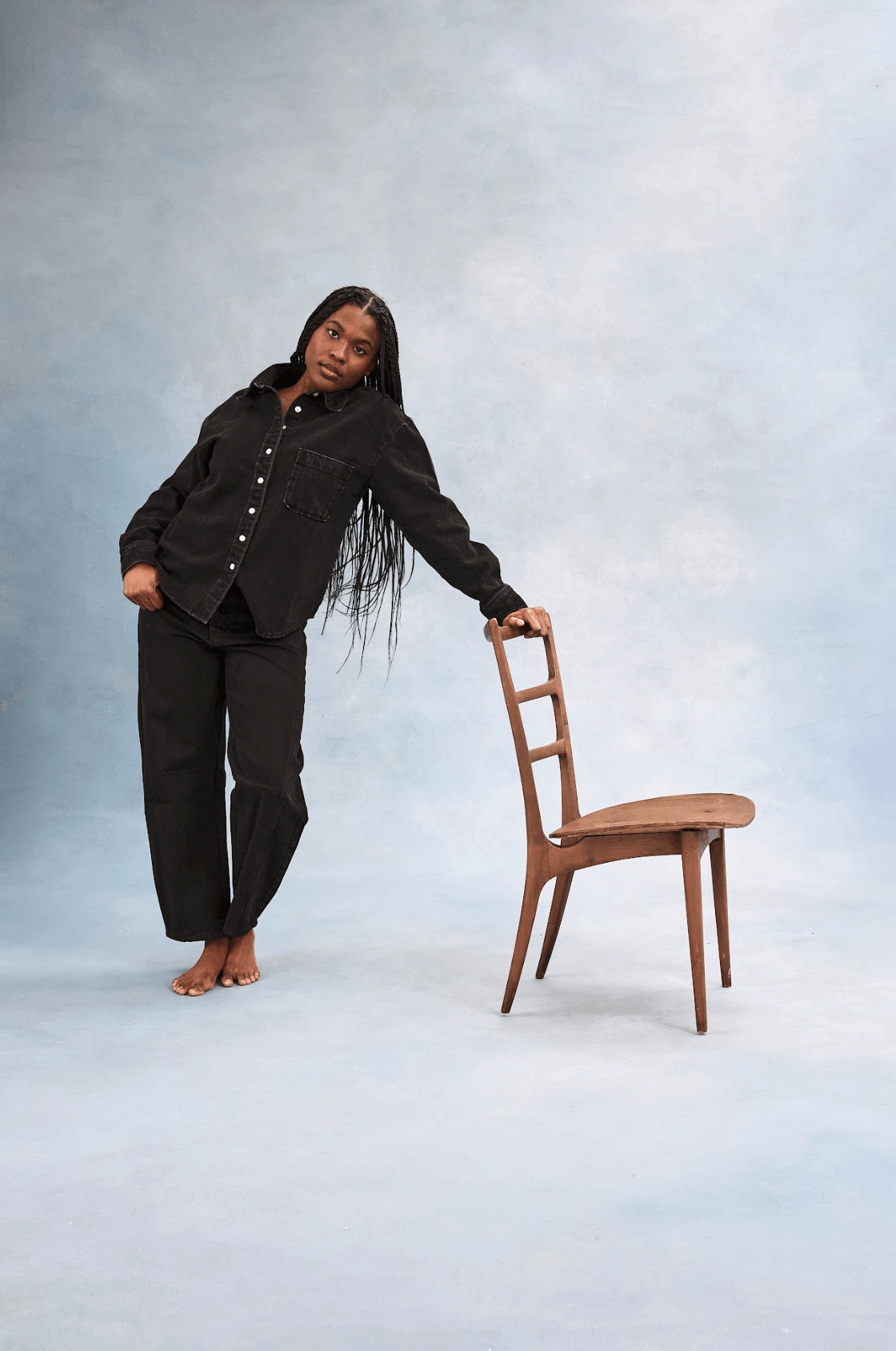girl holding chair wearing long sleeve button down - black