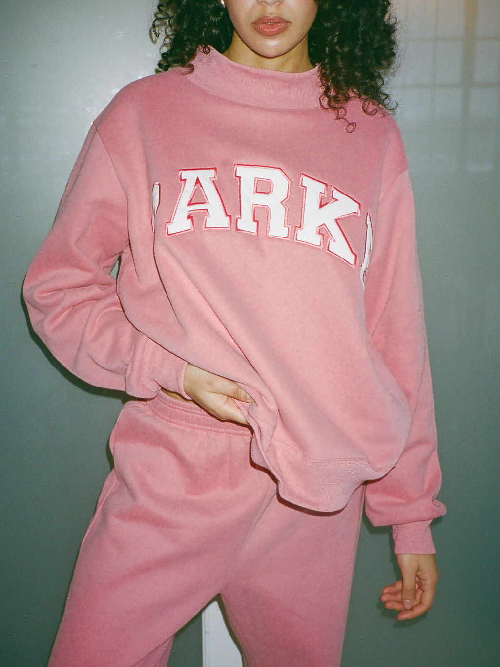 girl wearing varsity mockneck- bubblegum + white