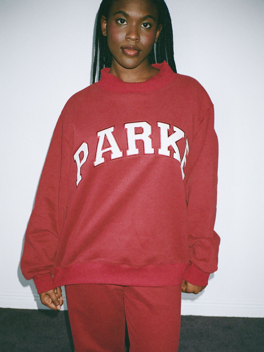 girl wearing varsity mockneck- burgundy + white