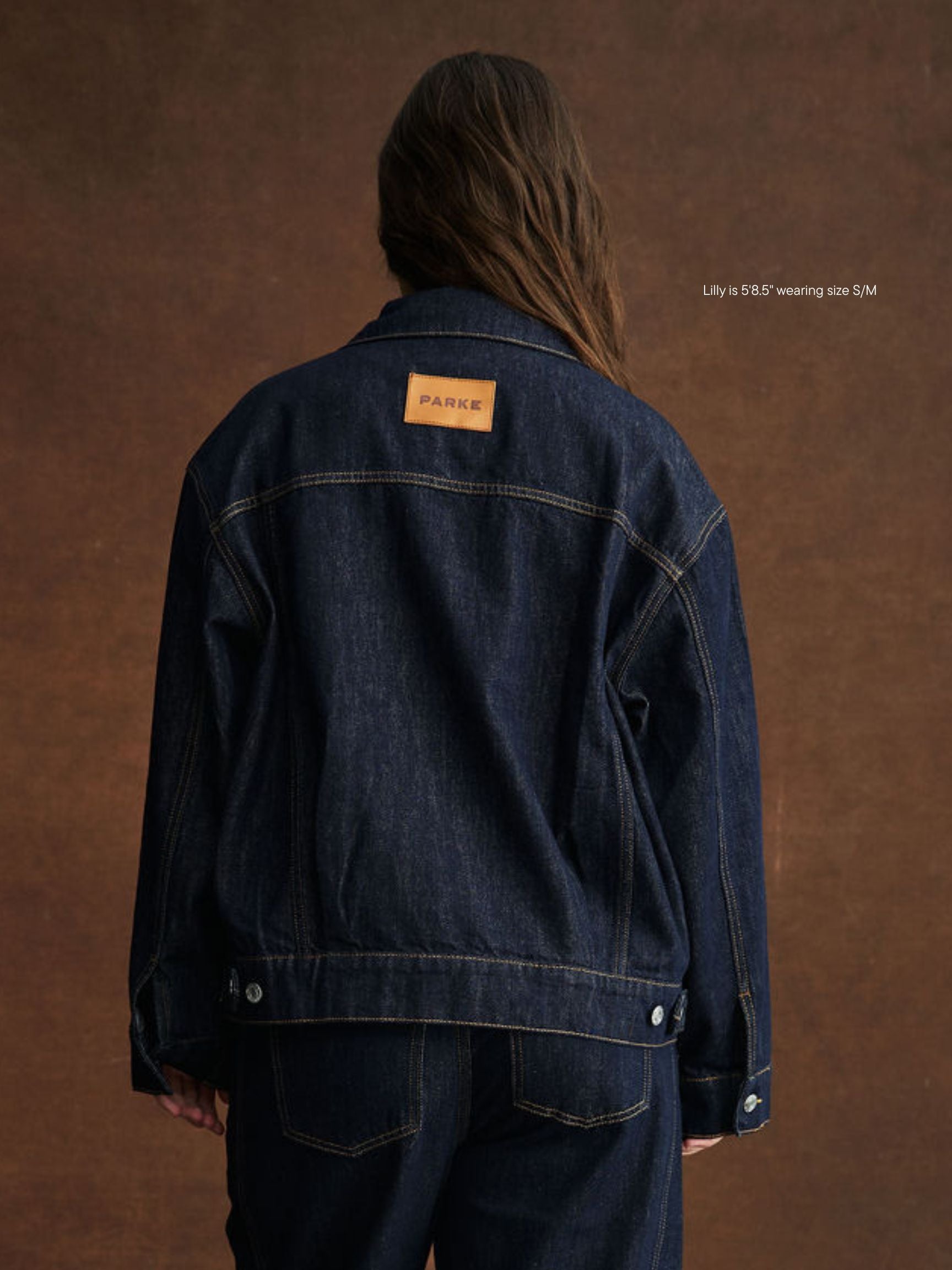 girl wearing oversized jean jacket -dark wash