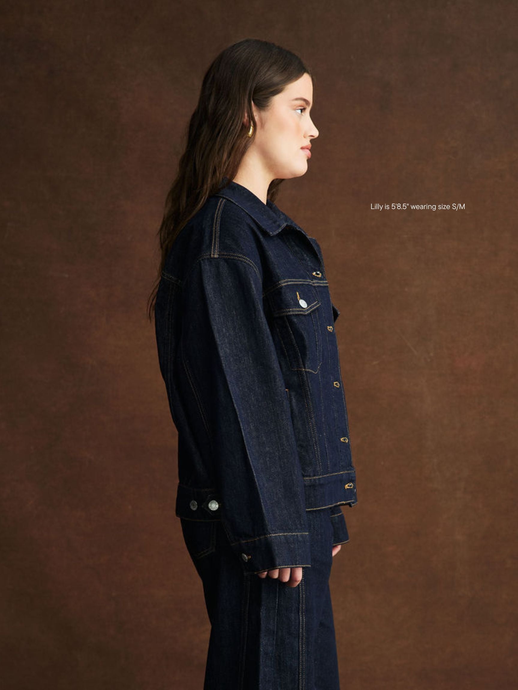 girl wearing oversized jean jacket -dark wash