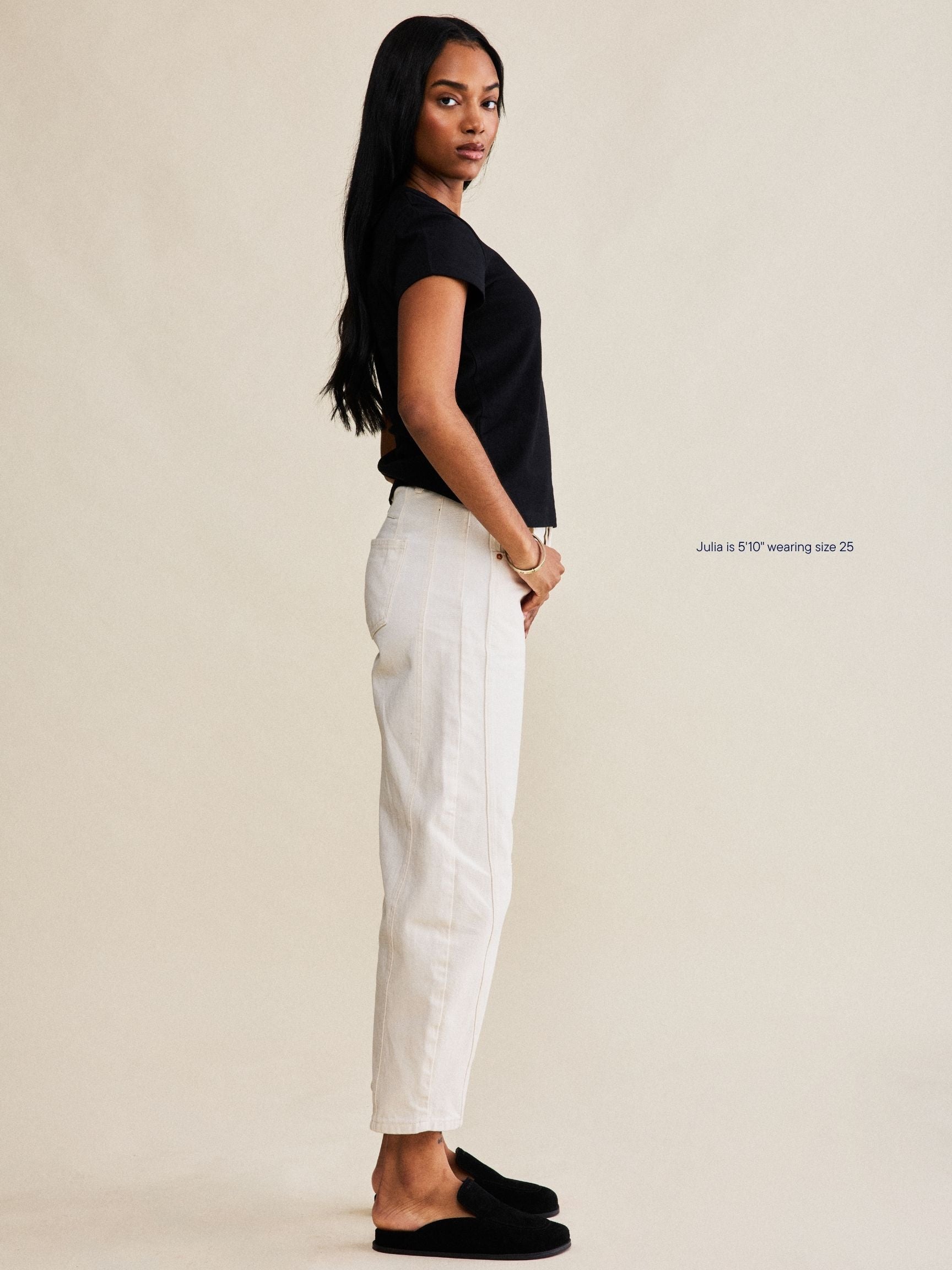 girl wearing horseshoe jeans -cream