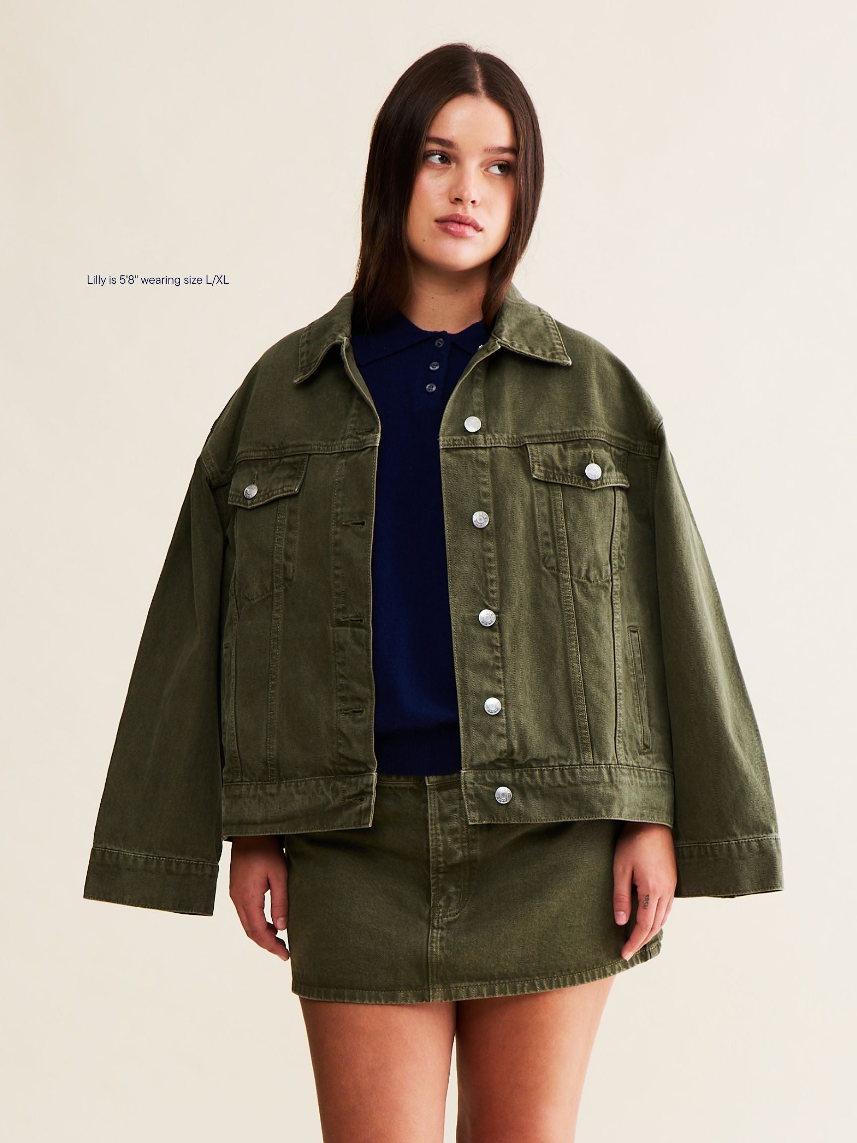 vintage wash girl wearing oversized denim jacket -olive