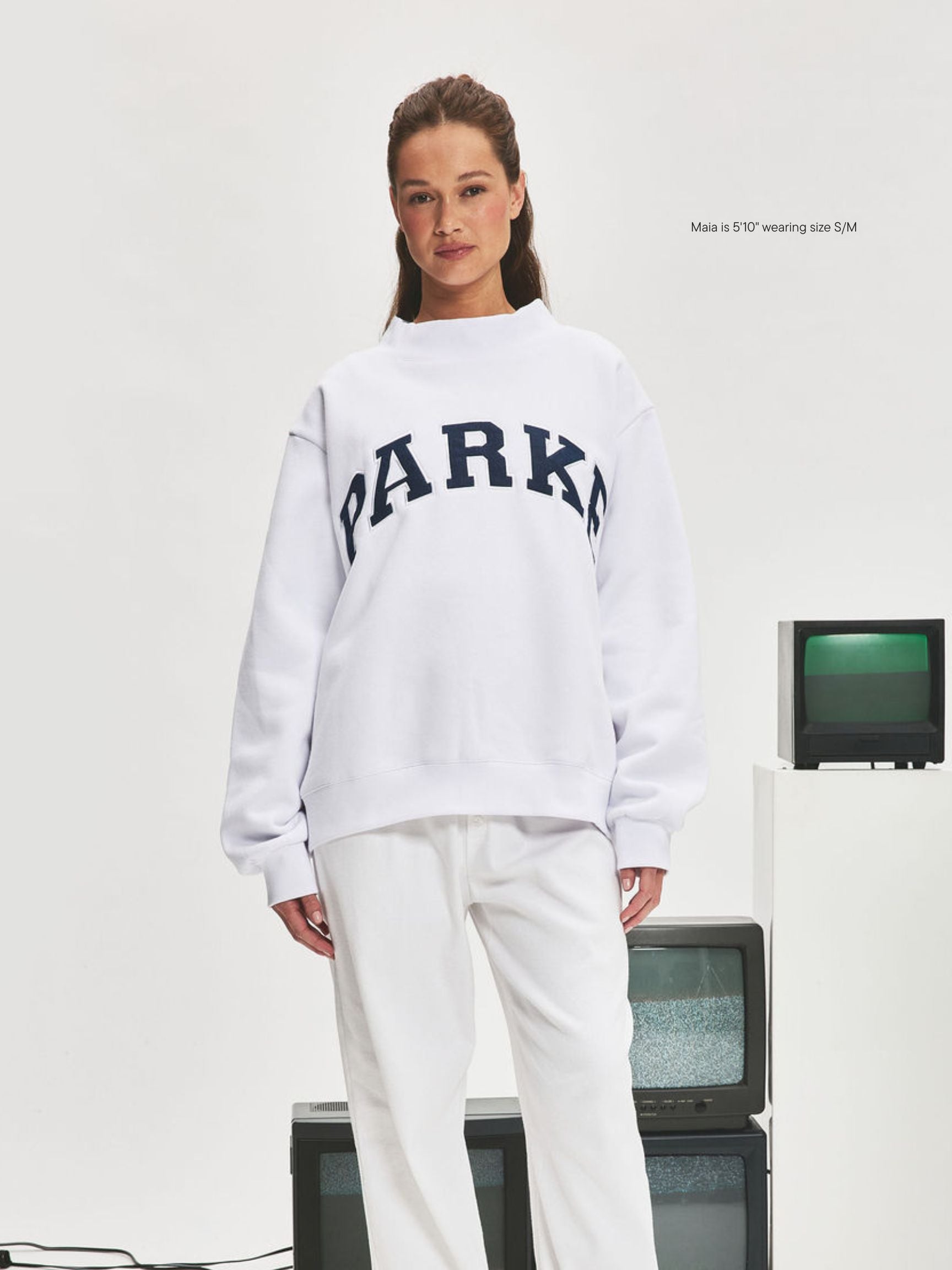 girl wearing Nostalgia Varsity Mockneck -white + denim