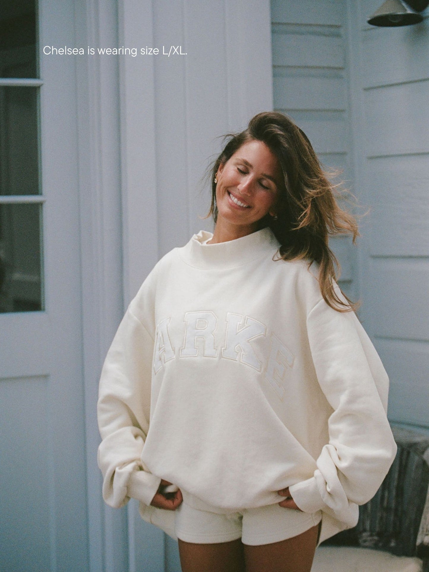 girl wearing varsity mockneck -cream