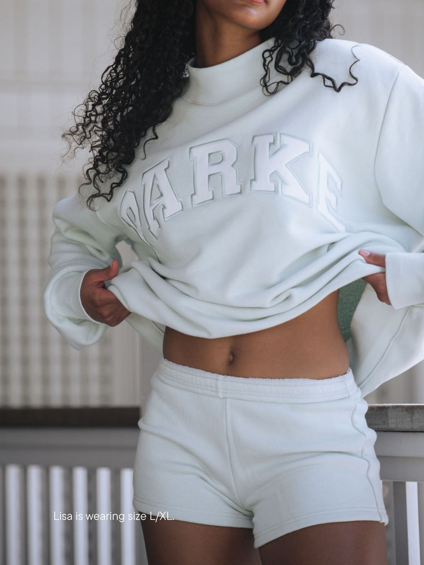 girl wearing varsity mockneck -something blue + white