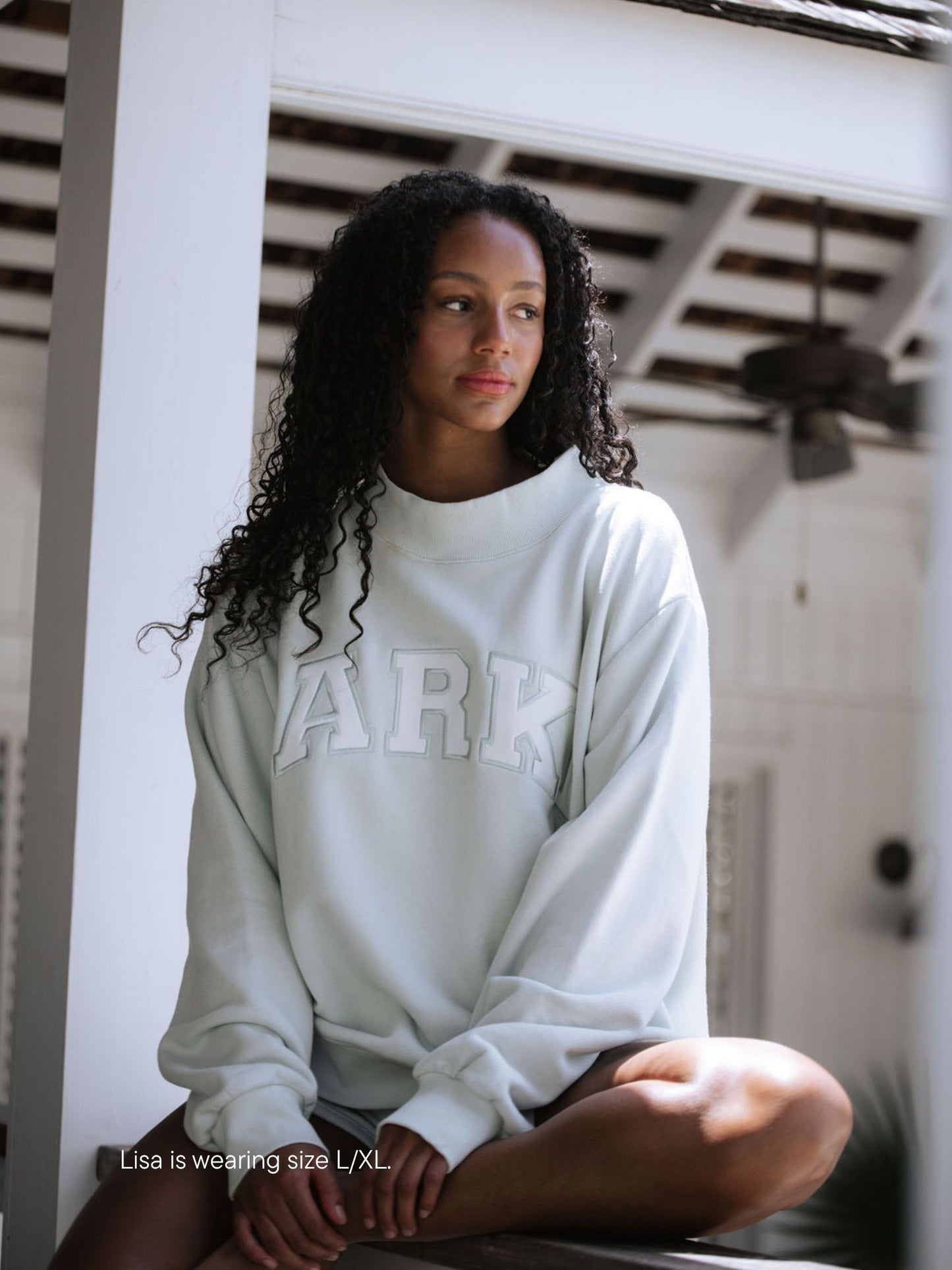 girl wearing varsity mockneck -something blue + white