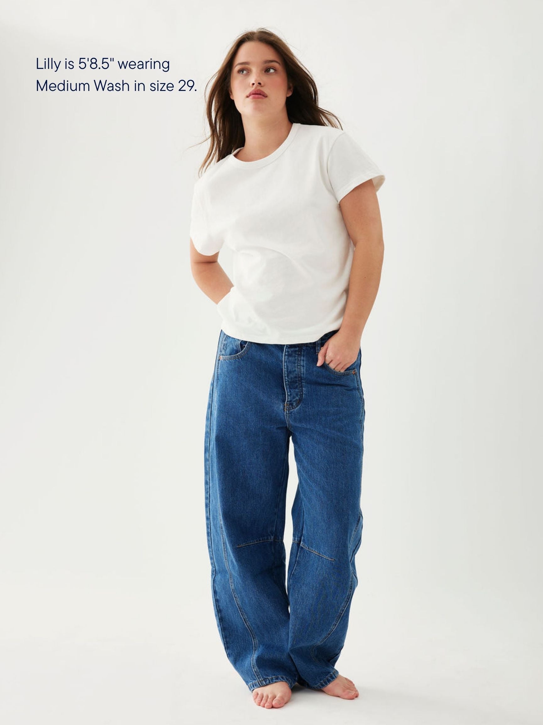 girl wearing horseshoe jeans -medium wash
