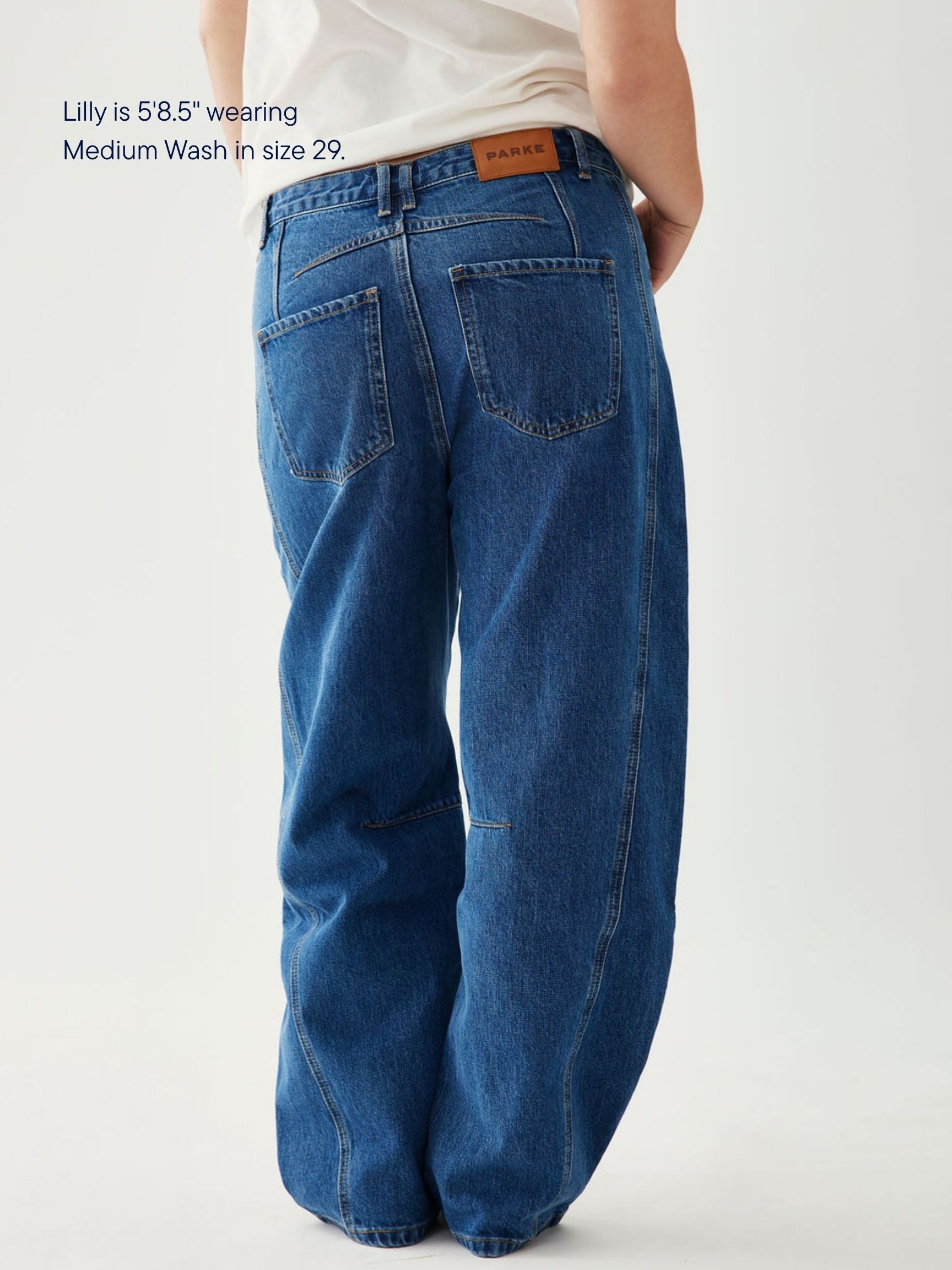 girl wearing horseshoe jeans -medium wash