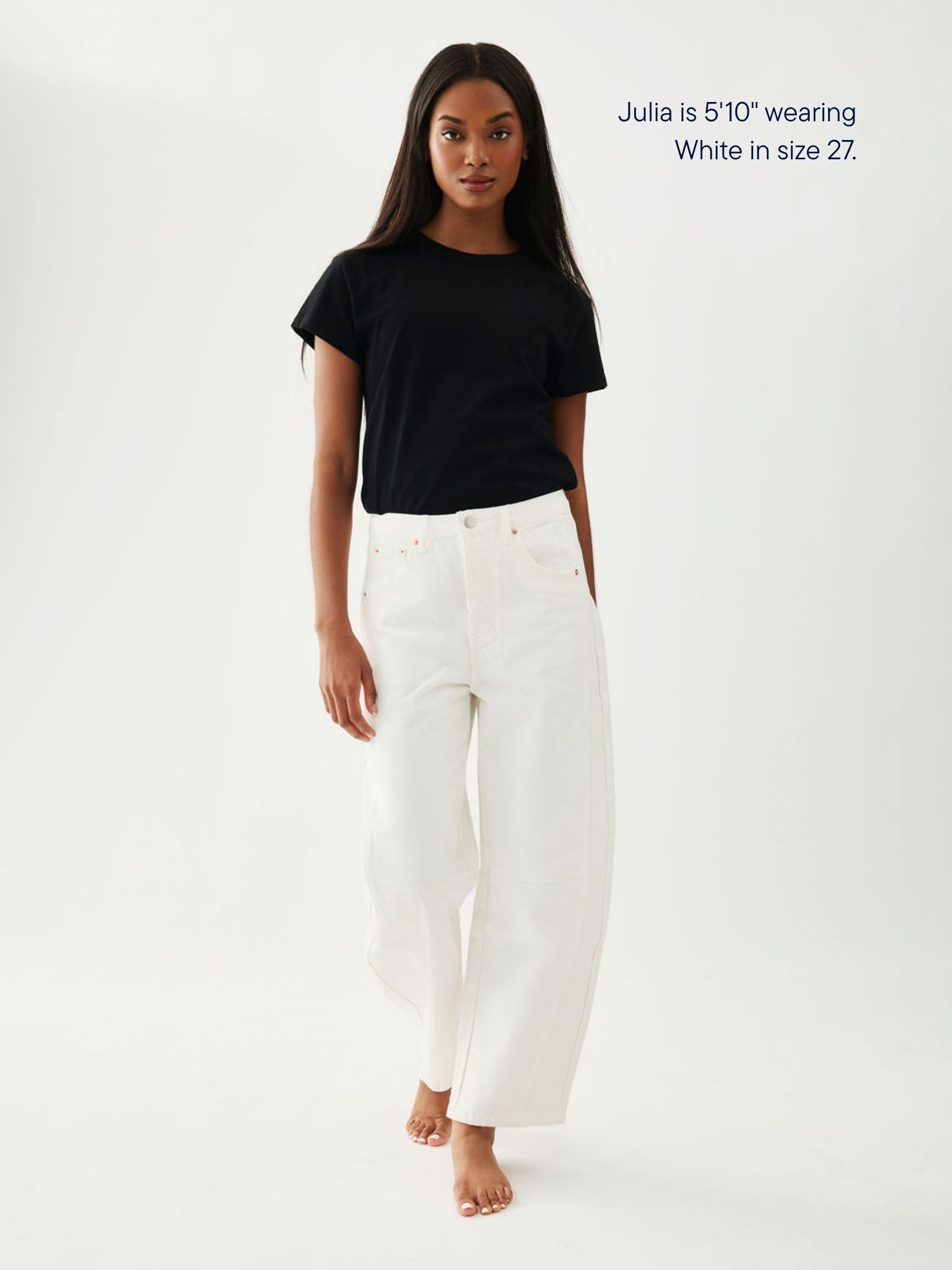 girl wearing horseshoe jeans -white