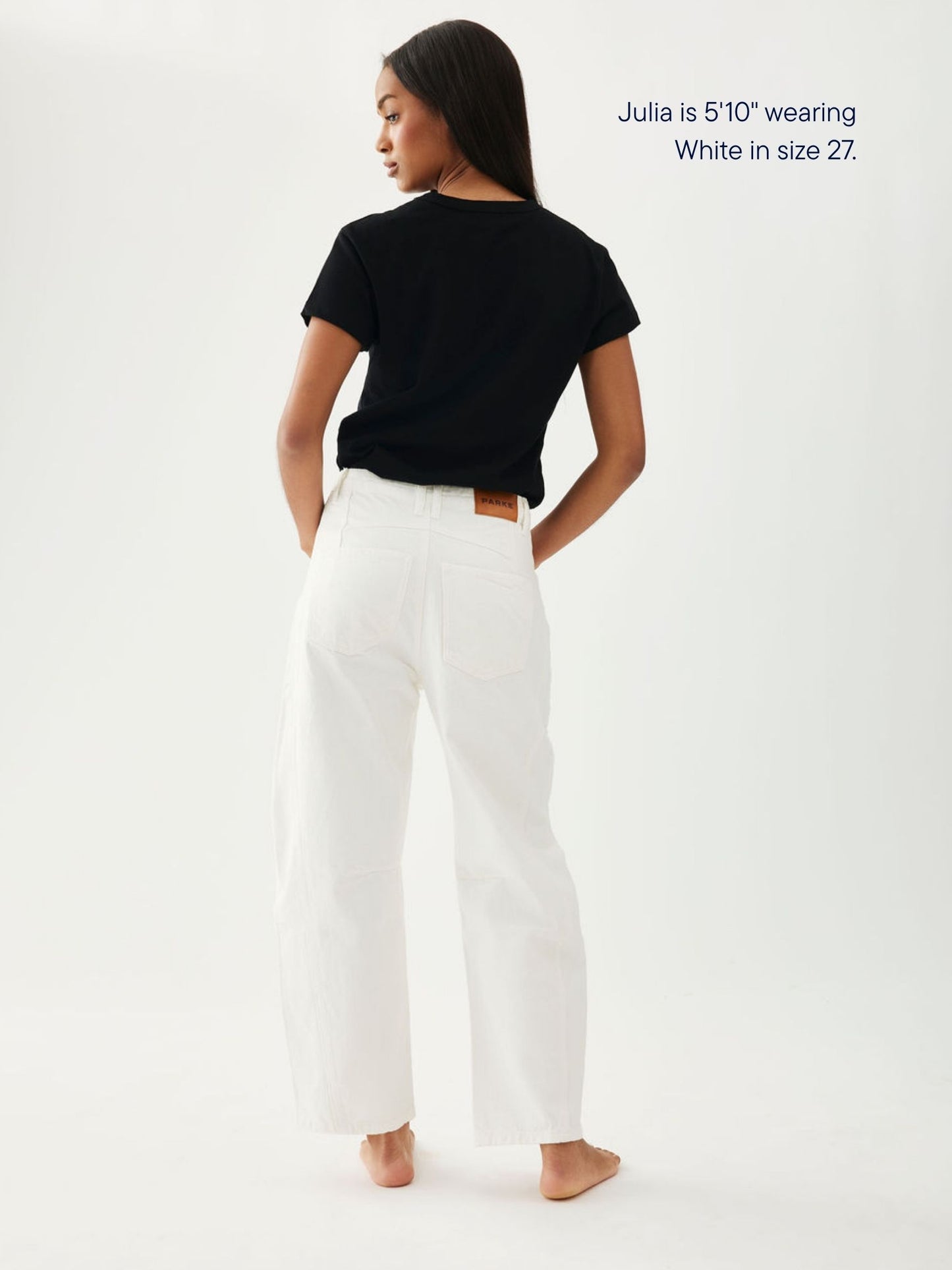 girl wearing horseshoe jeans -white
