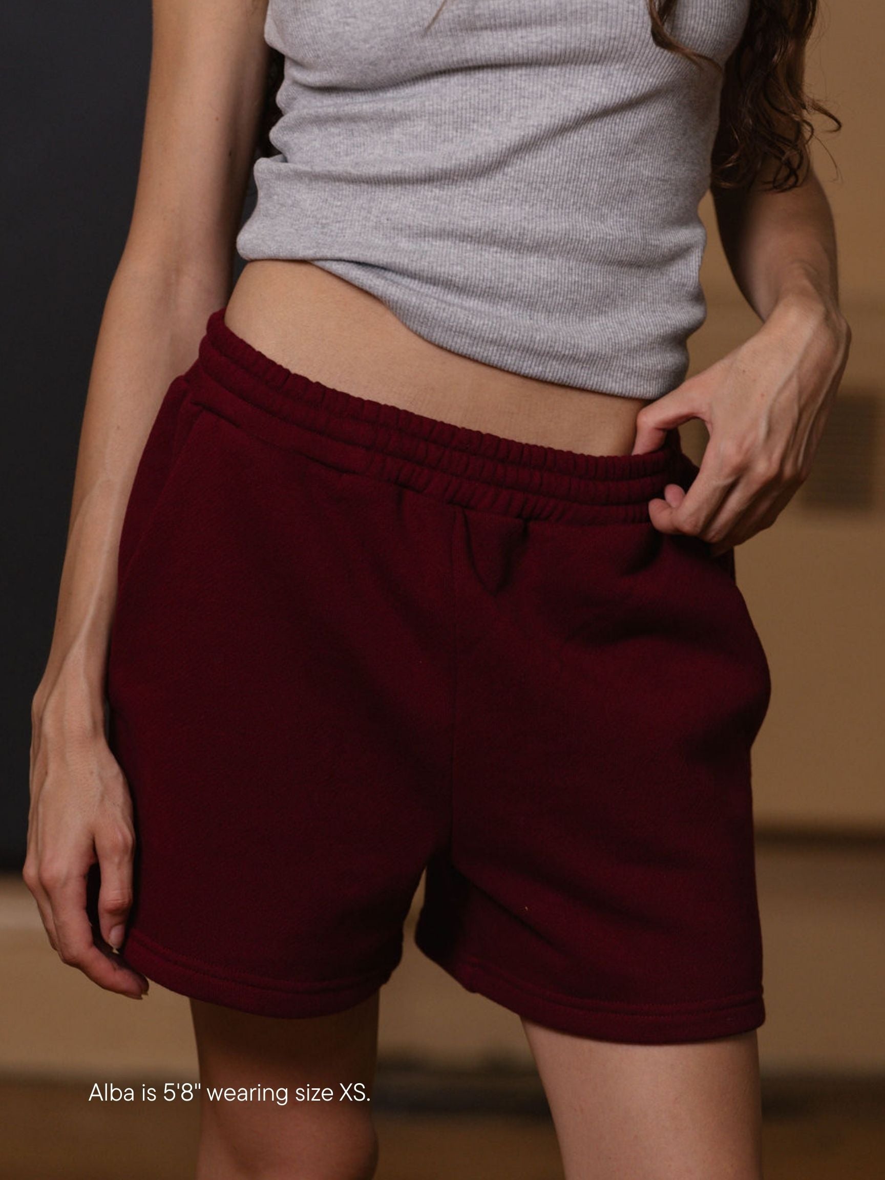 girl wearing lounge sweatshorts -maroon