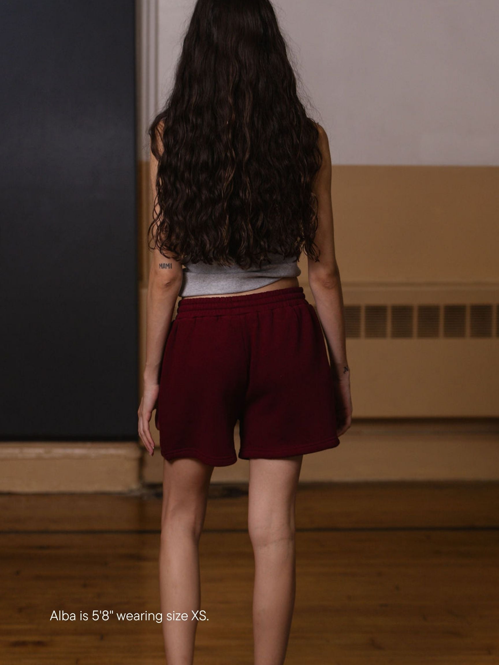 girl wearing lounge sweatshorts -maroon