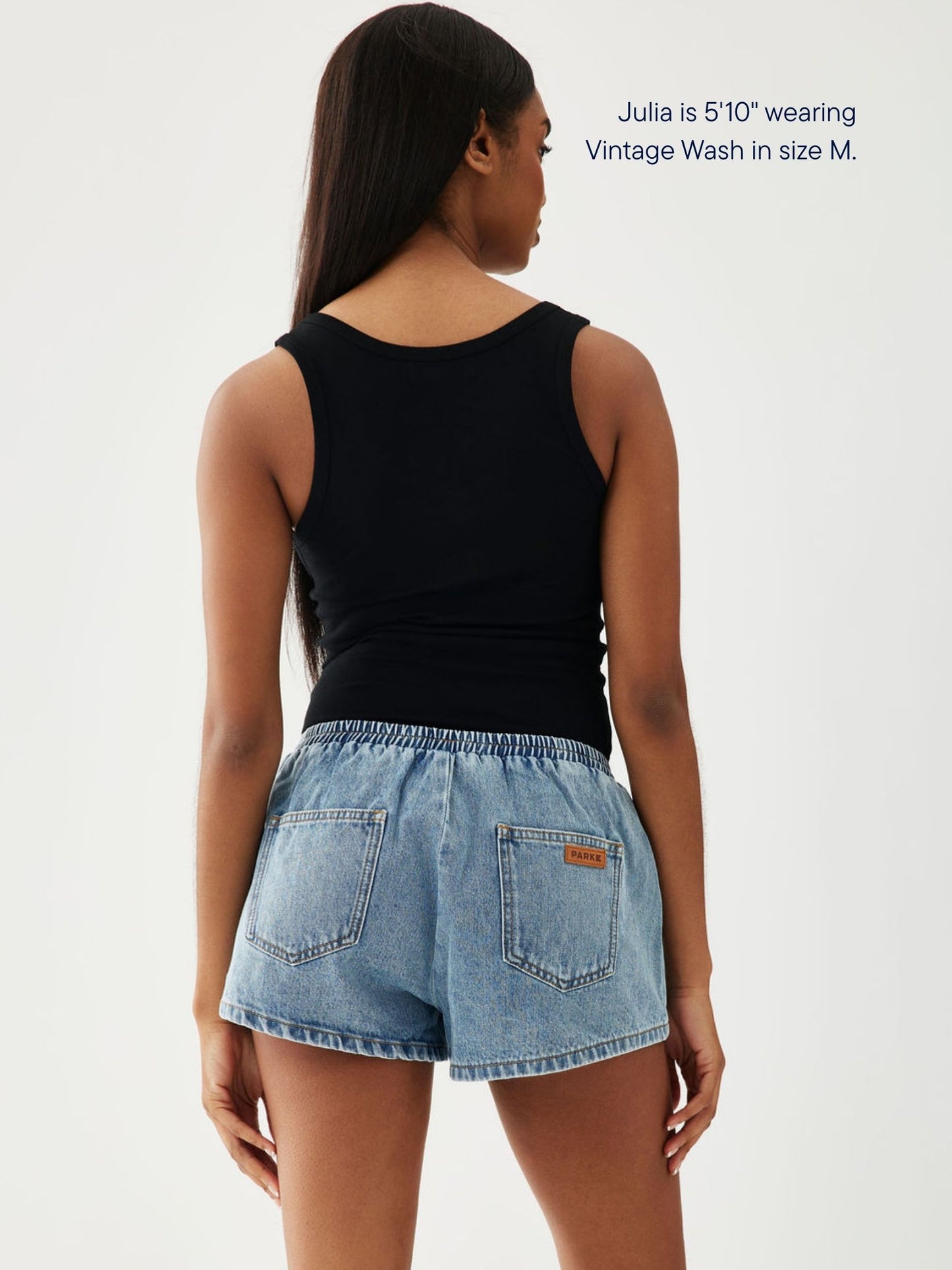 girl wearing elastic denim mini short -vintage wash