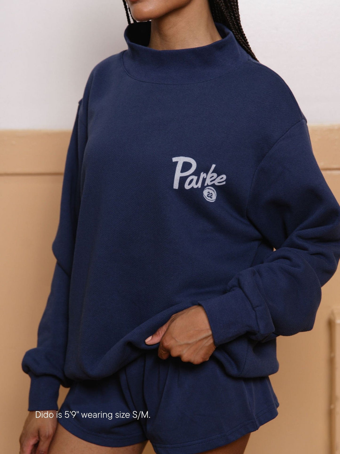 girl wearing kick off mockneck -denim