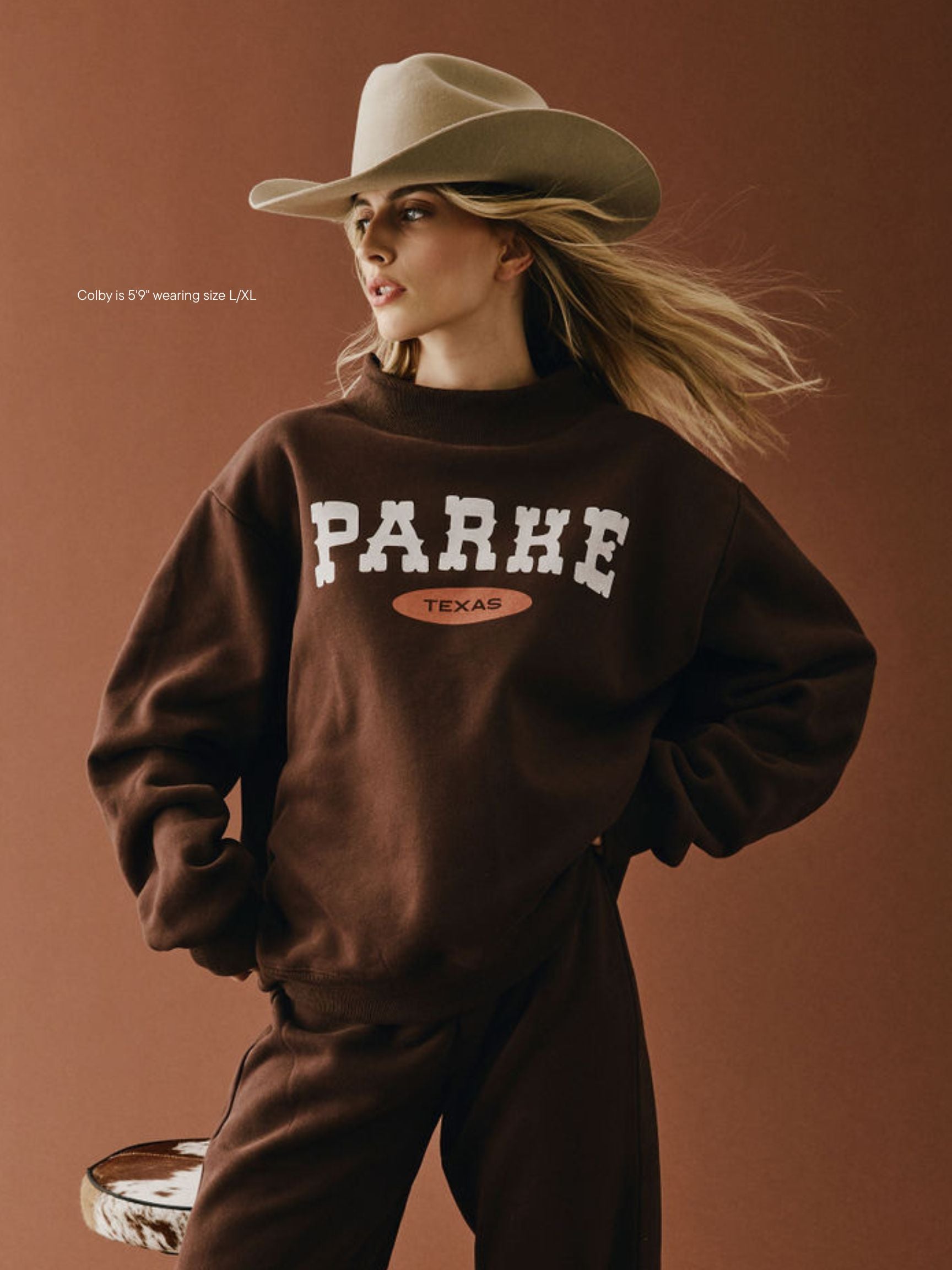 girl wearing Cities Signature Mockneck -cowboy texas
