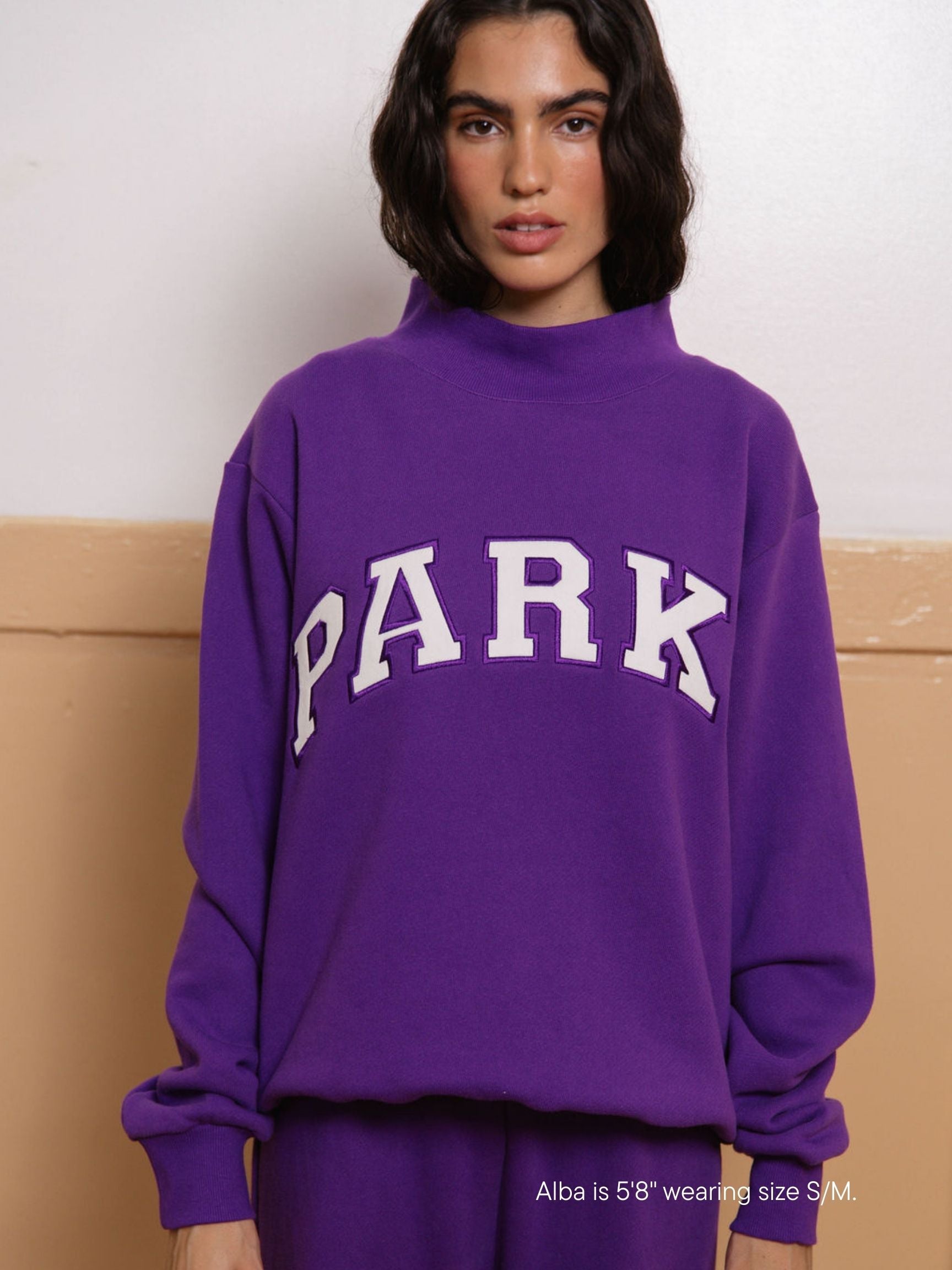 girl wearing back to school varsity mockneck -amethyst + white