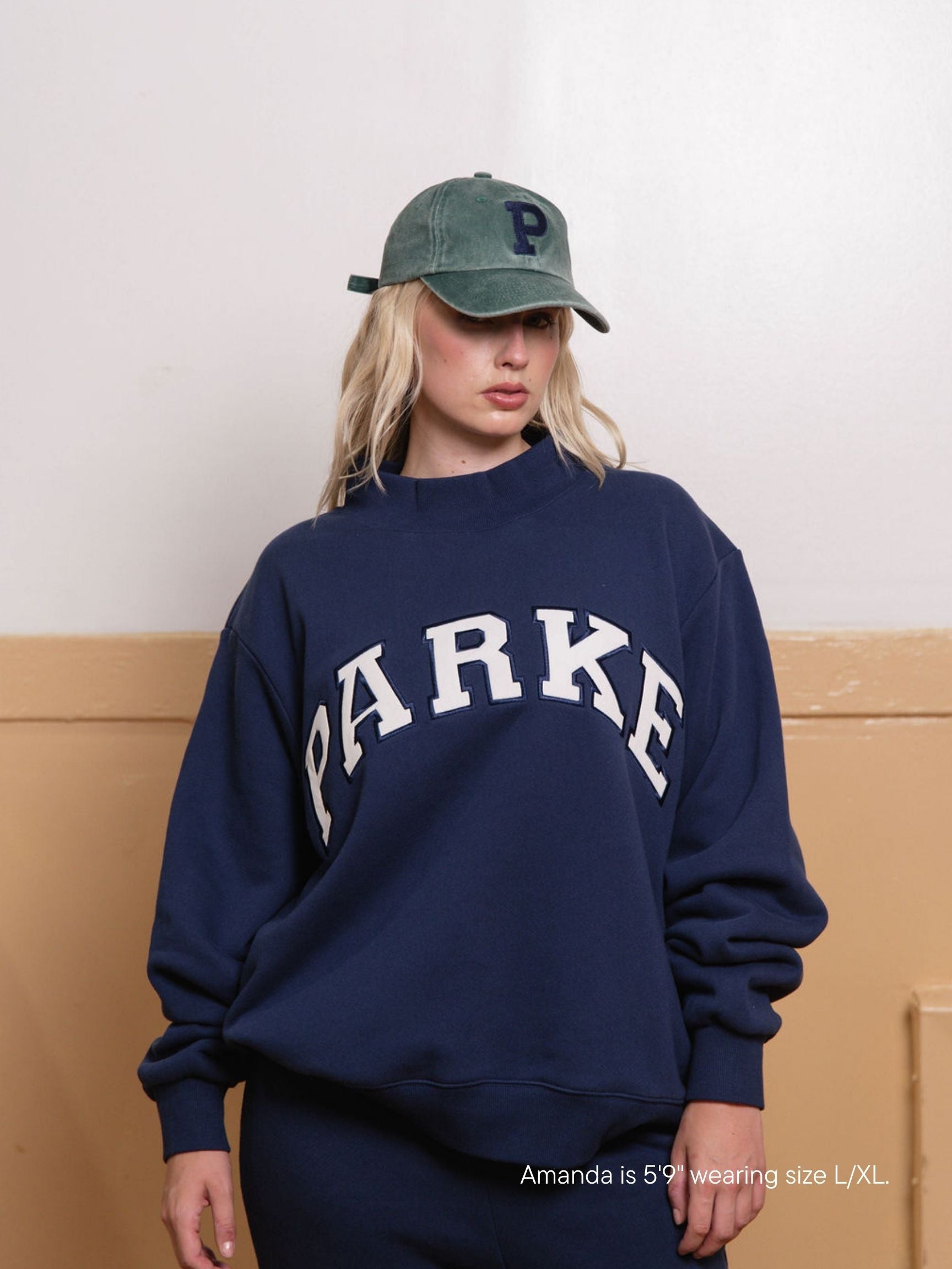 girl wearing back to school varsity mockneck -denim + white