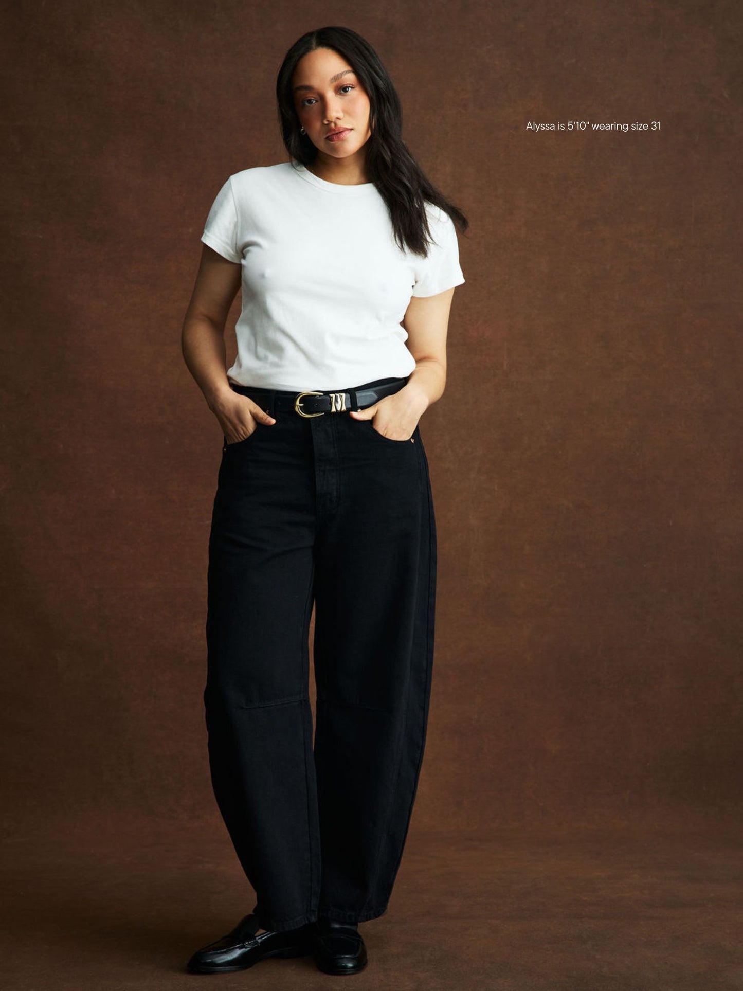 girl wearing black horseshoe jean -black