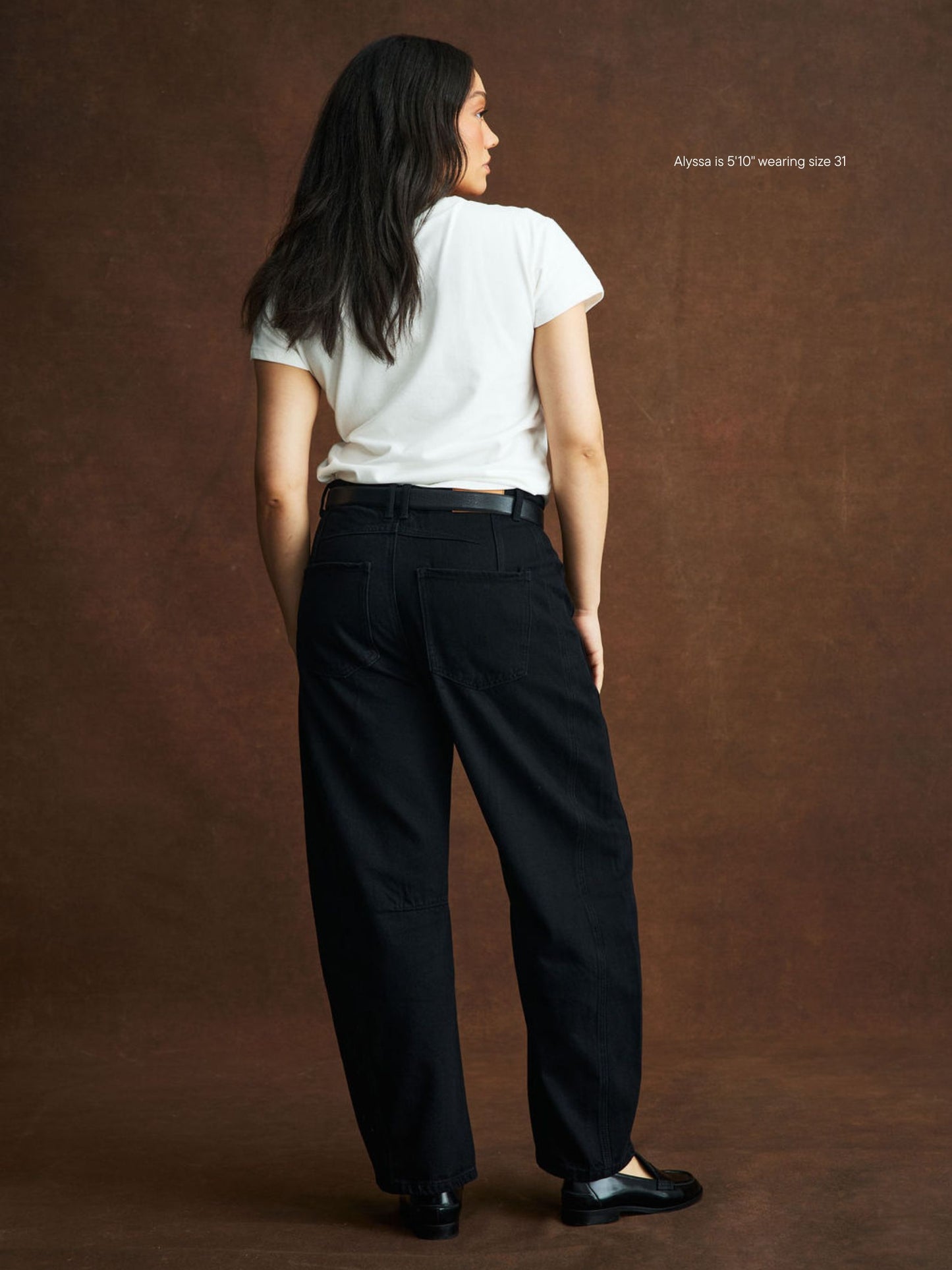 girl wearing black horseshoe jean -black