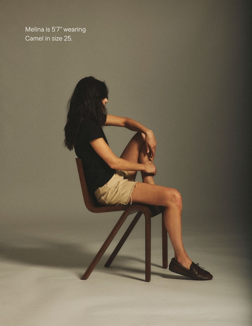girl wearing long baggy shorts -camel