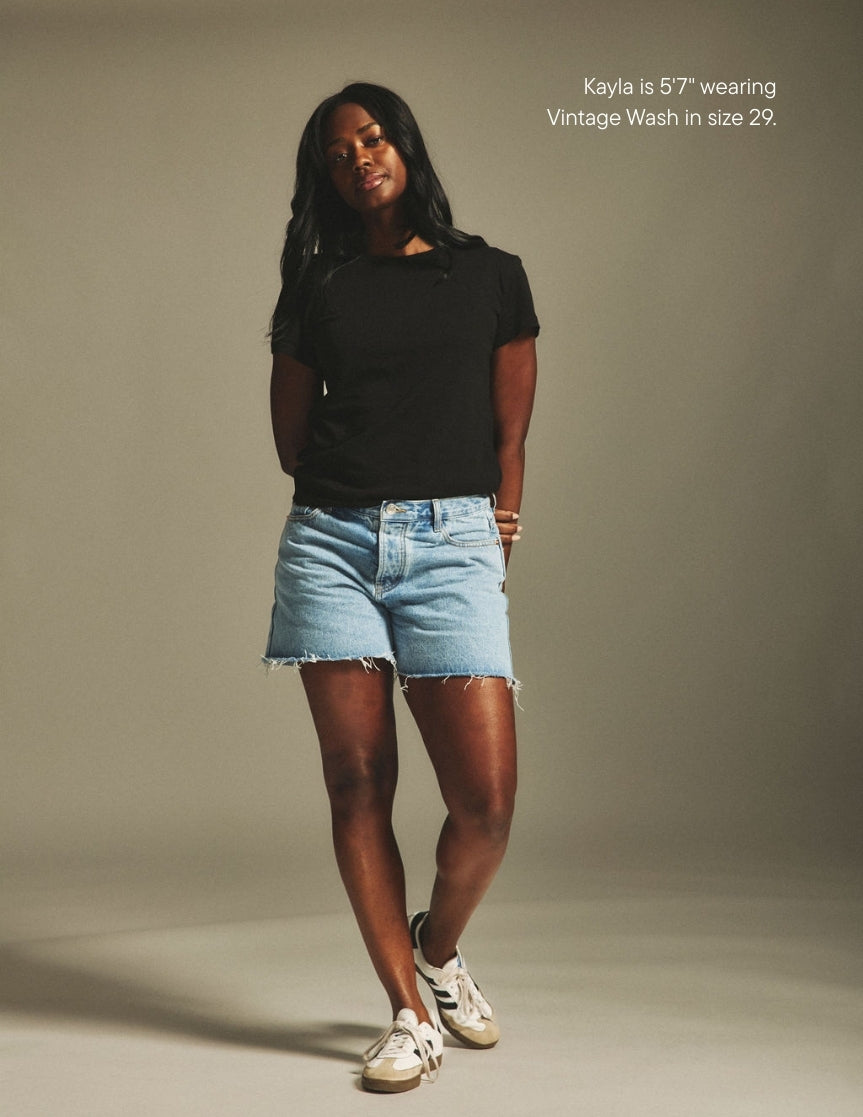 girl wearing long baggy shorts -vintage wash
