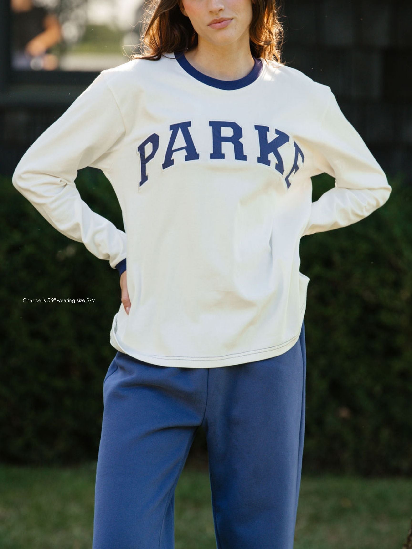 girl wearing varsity long sleeve -crown blue