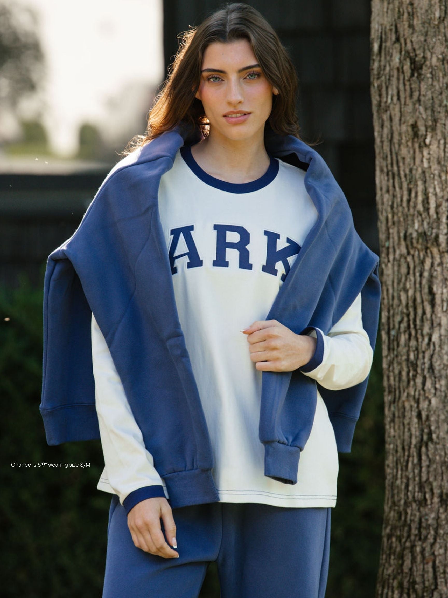 girl wearing varsity long sleeve -crown blue