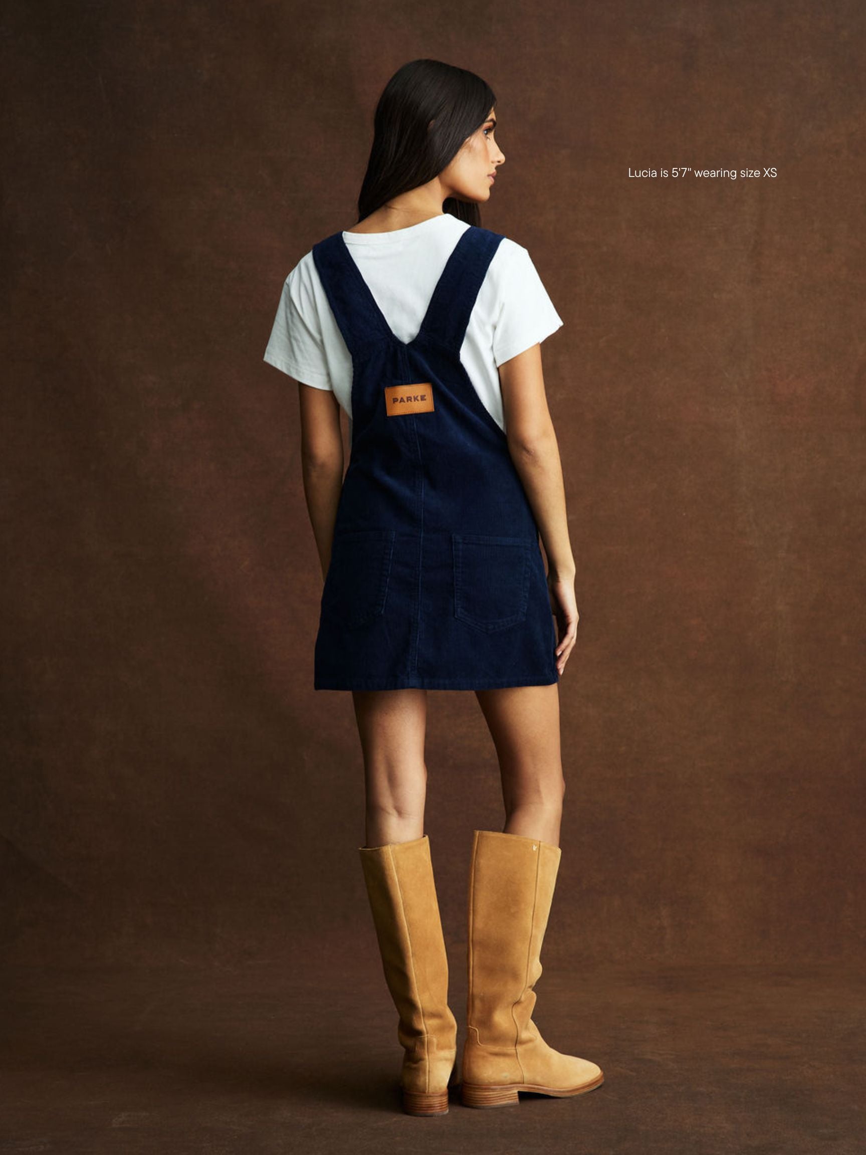 girl wearing Corduroy Overall Mini Dress -navy corduroy 