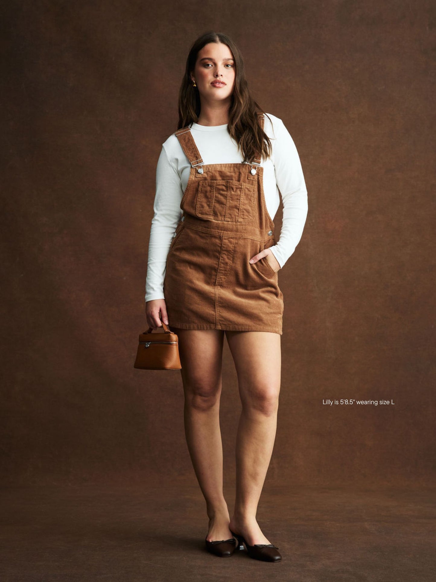 girl wearing Corduroy Overall Mini Dress -caramel corduroy 