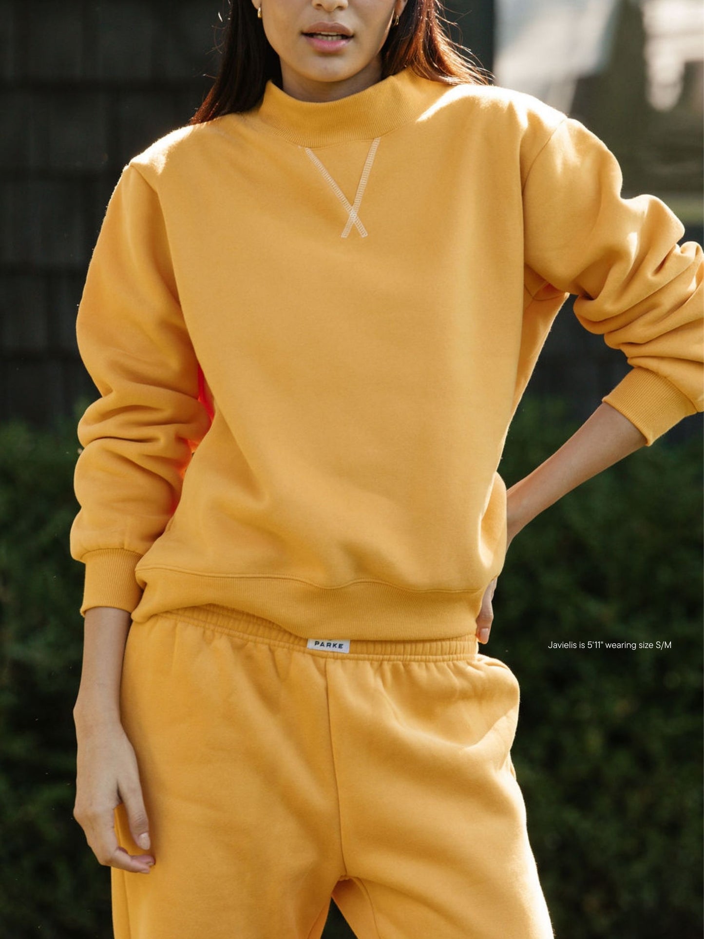 girl wearing charcoal classic mockneck -apricot