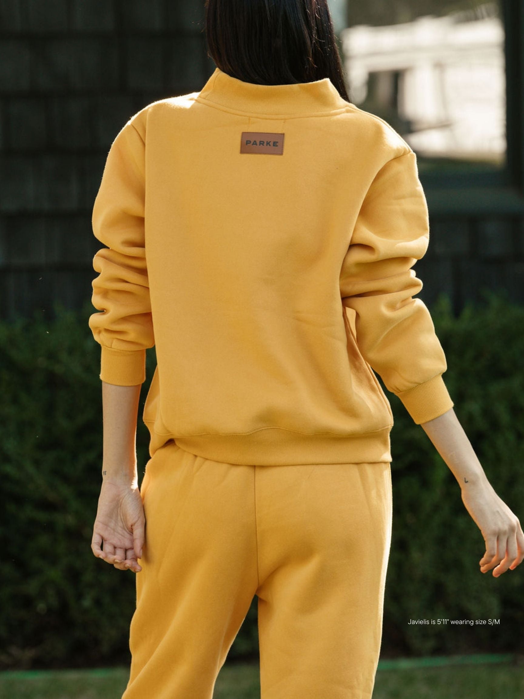 girl wearing charcoal classic mockneck -apricot