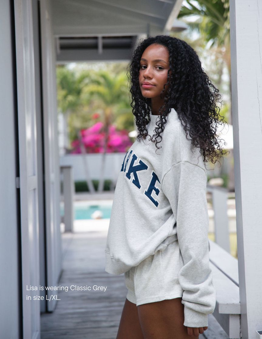 girl wearing heritage varsity mockneck -classic grey + denim